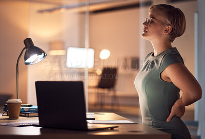 Buy stock photo Woman, office and night for back pain injury, burnout or stress at desk for overtime, fatigue or tired. Young corporate worker, manager and muscle strain in dark workplace, frustrated and stretching