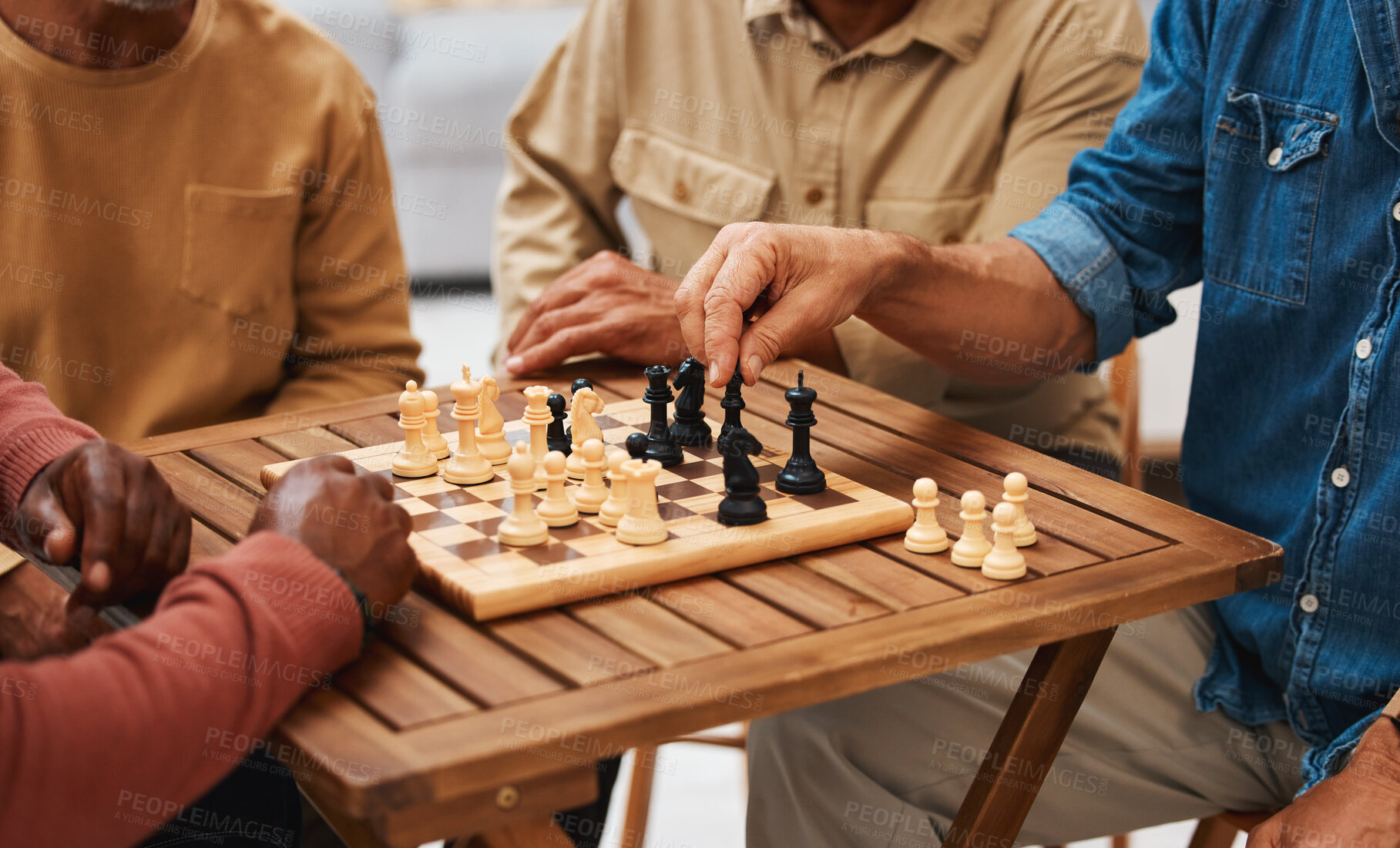 Buy stock photo Hands, chess and friends in board games on wooden table for strategic competition, tactical move or decision. Hand of skilled strategy player holding black bishop playing game with friend in tactics