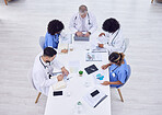 Doctors, nurses or hospital meeting on laptop for research, teamwork or workshop innovation of hospital medicine. Planning, men or healthcare diversity women on technology collaboration in top view