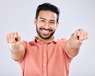 Buy stock photo Portrait, pointing and motivation with a man in studio on a gray background choosing an option or selection. Happy, smile and hey you with a handsome young male making a choice or decision