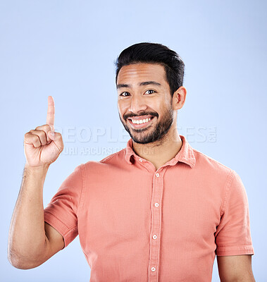 Buy stock photo Happy, portrait and man pointing in a studio to mockup space for advertising, marketing or product placement. Happiness, smile and male model showing mock up while isolated by a purple background.