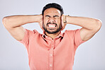 Psychosis, mental health and angry Asian man with bipolar isolated on a grey studio background. Stress, fear and scared guy closing ears for noise, scared and suffering with rage on a backdrop