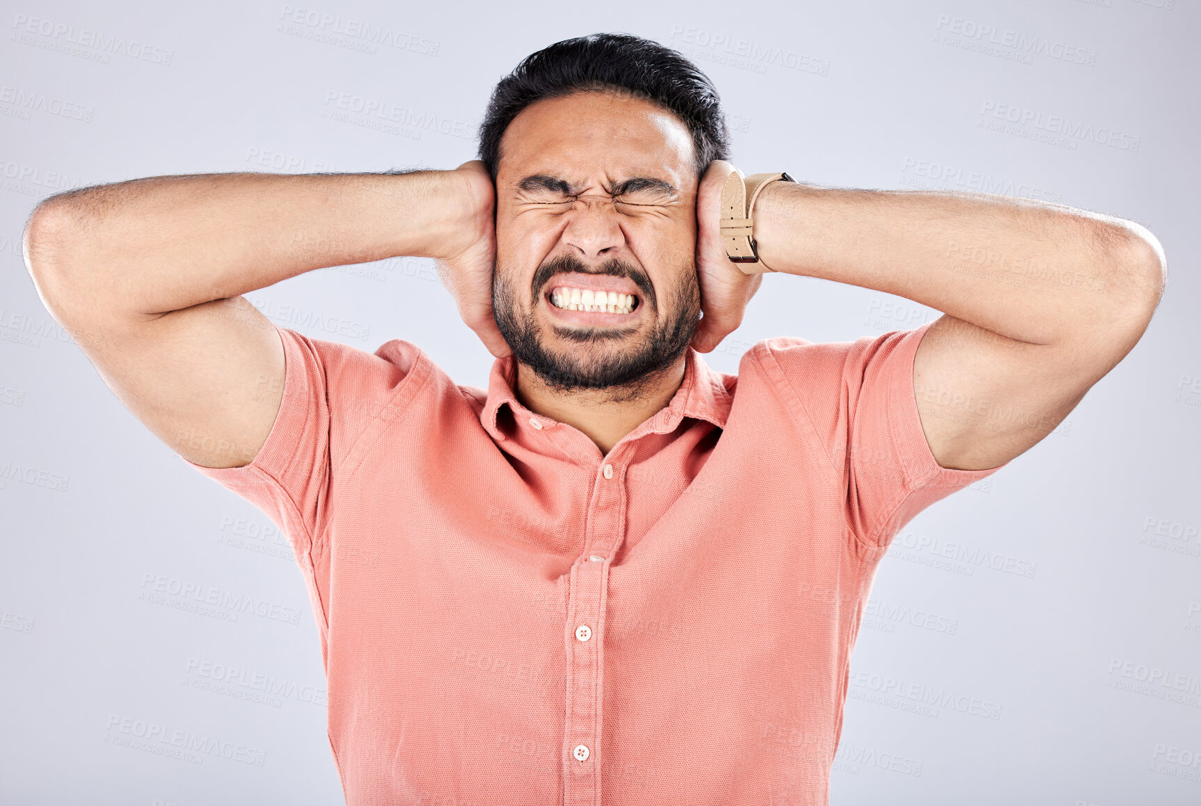 Buy stock photo Psychosis, mental health and angry Asian man with bipolar isolated on a grey studio background. Stress, fear and scared guy closing ears for noise, frustration and suffering with rage on a backdrop