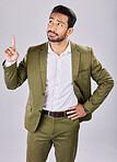 Pointing, solution and idea with man in studio for thinking, product placement and direction. Isolated, confident and question with guy and gesture for development, alert and show in gray background