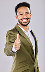 Business portrait, smile and Asian man with thumbs up in studio isolated on a gray background. Ceo, boss and happy male entrepreneur with hand gesture or emoji for yes, success agreement or thank you