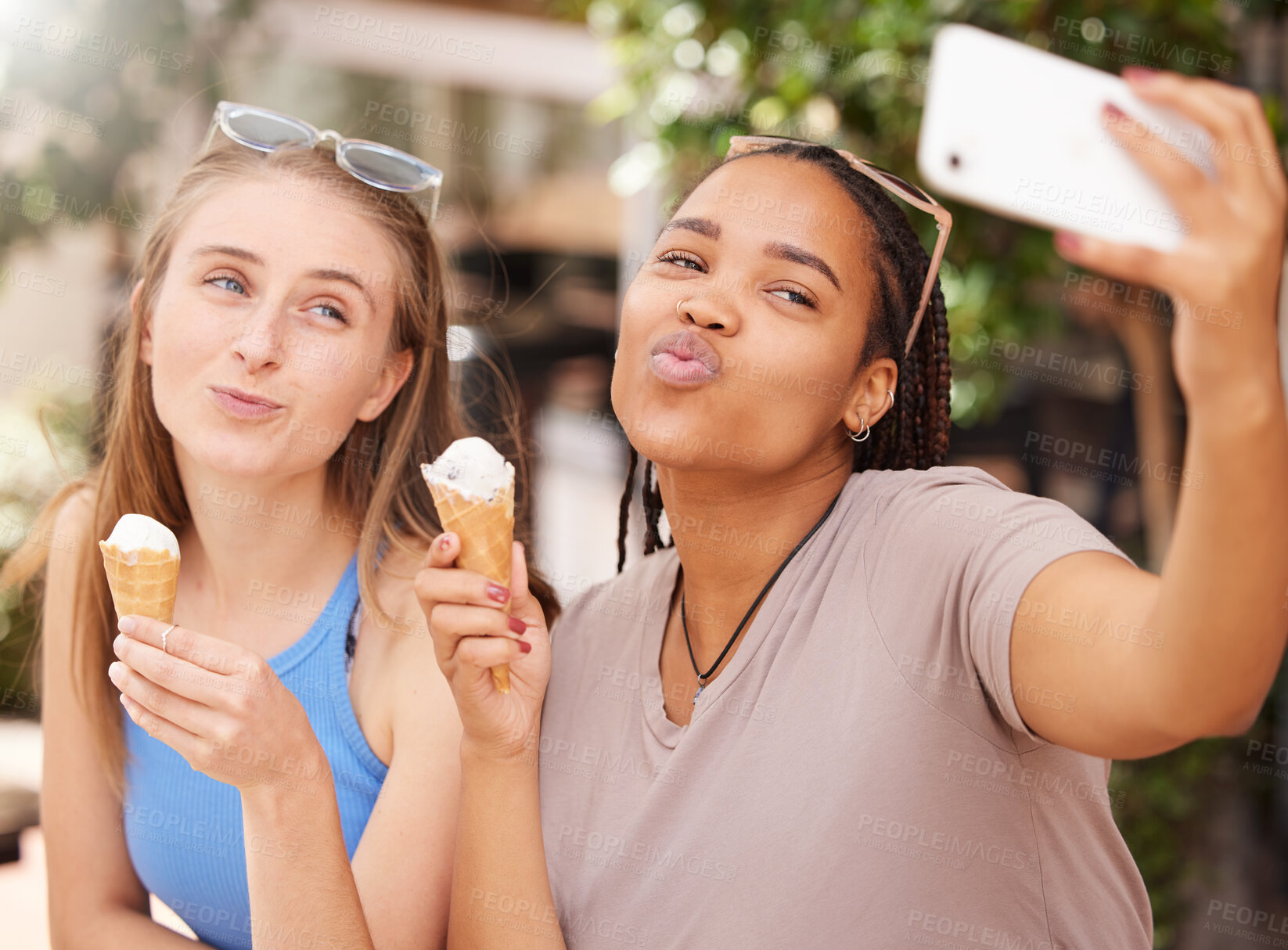 Buy stock photo Friends with ice cream, kiss and selfie outdoor with travel, happy with dessert and spending time together on vacation. Social media post, pout face in picture and young female eating gelato in Italy