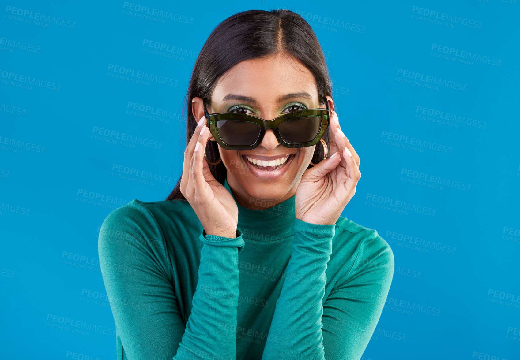 Buy stock photo Sunglasses, fashion and woman with cool style and smile feeling happy and excited isolated in studio blue background. Portrait, young and model or trendy gen z female with stylish beauty