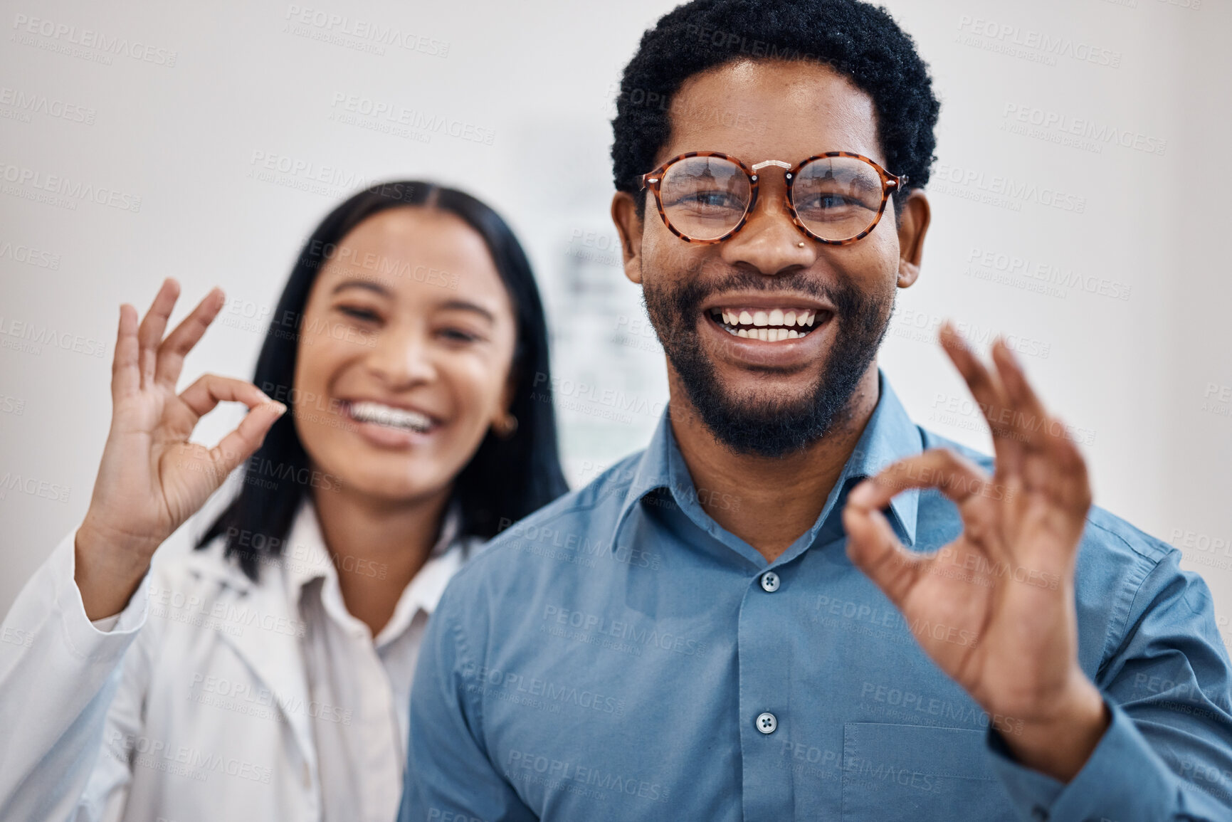 Buy stock photo Perfect, optometry and portrait of a black man and optician with glasses, eyecare and choice of eyewear. Okay, happy and patient with a decision on eyeglasses with an optometrist and hand gesture