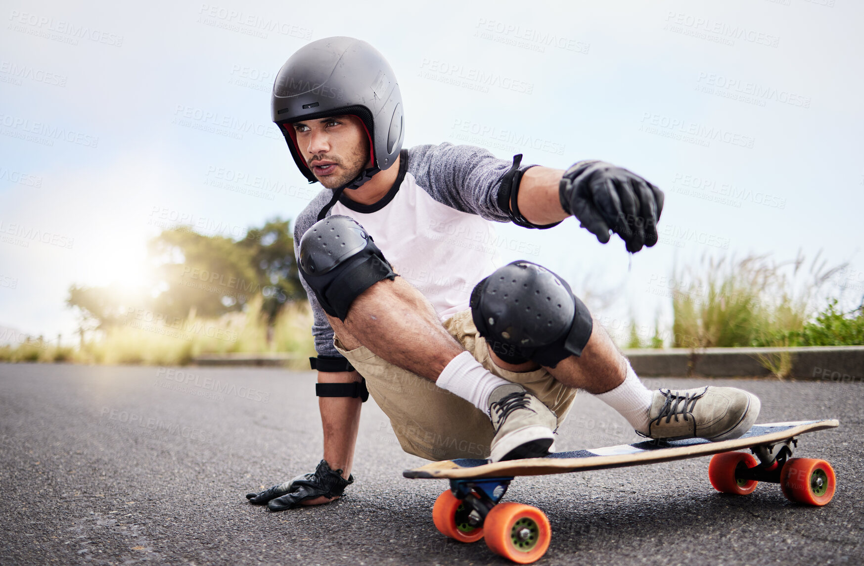 Buy stock photo Skateboard slide, action and man in road for sports competition, training and balance in city. Skating, skateboarding hobby and male skater in gear riding for speed, adventure and race adrenaline