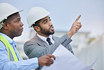 Engineering, teamwork and leader with blueprint at construction site for development. Architecture, collaboration and manager, contractor men or architect colleagues pointing, planning and discussion