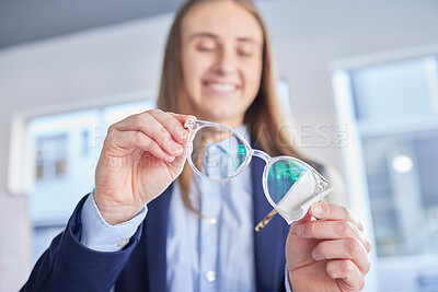 Buy stock photo Hands, glasses and an optometrist woman cleaning lenses in a store to sell a product for fashion. Vision, eyewear and optometry with a female optician wiping a pair of frame eyeglasses for eyesight