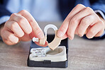Hearing aid, disability help tool and hands with hospital, wellness and medical audio innovation. Listening, audio and deaf device for healthcare, disabled people and implant for language hear