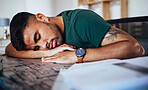 Tired, burnout and man sleeping on a desk after studying, education or stress from remote work. Lazy, nap and student with fatigue, sleep and resting after learning, exam preparation and homework