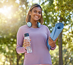 Fitness, woman and portrait smile for yoga, spiritual wellness or healthy lifestyle in nature. Happy female yogi smiling with water bottle, mat and headphones for calm exercise or workout in the park