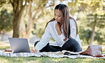 Nature, laptop and student studying in the park for a university test, exam or assignment. Technology, outdoor and woman writing notes while working on a college project with a computer in a garden.