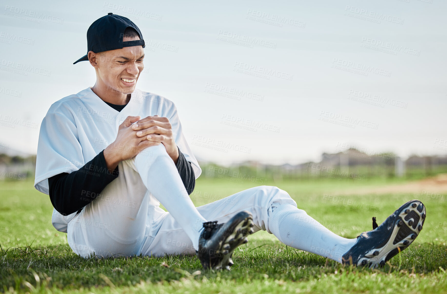 Buy stock photo Baseball, pain and man with knee injury on field after accident, fall or workout in match. Sports, training and male athlete with fibromyalgia, inflammation or broken leg, arthritis or tendinitis.