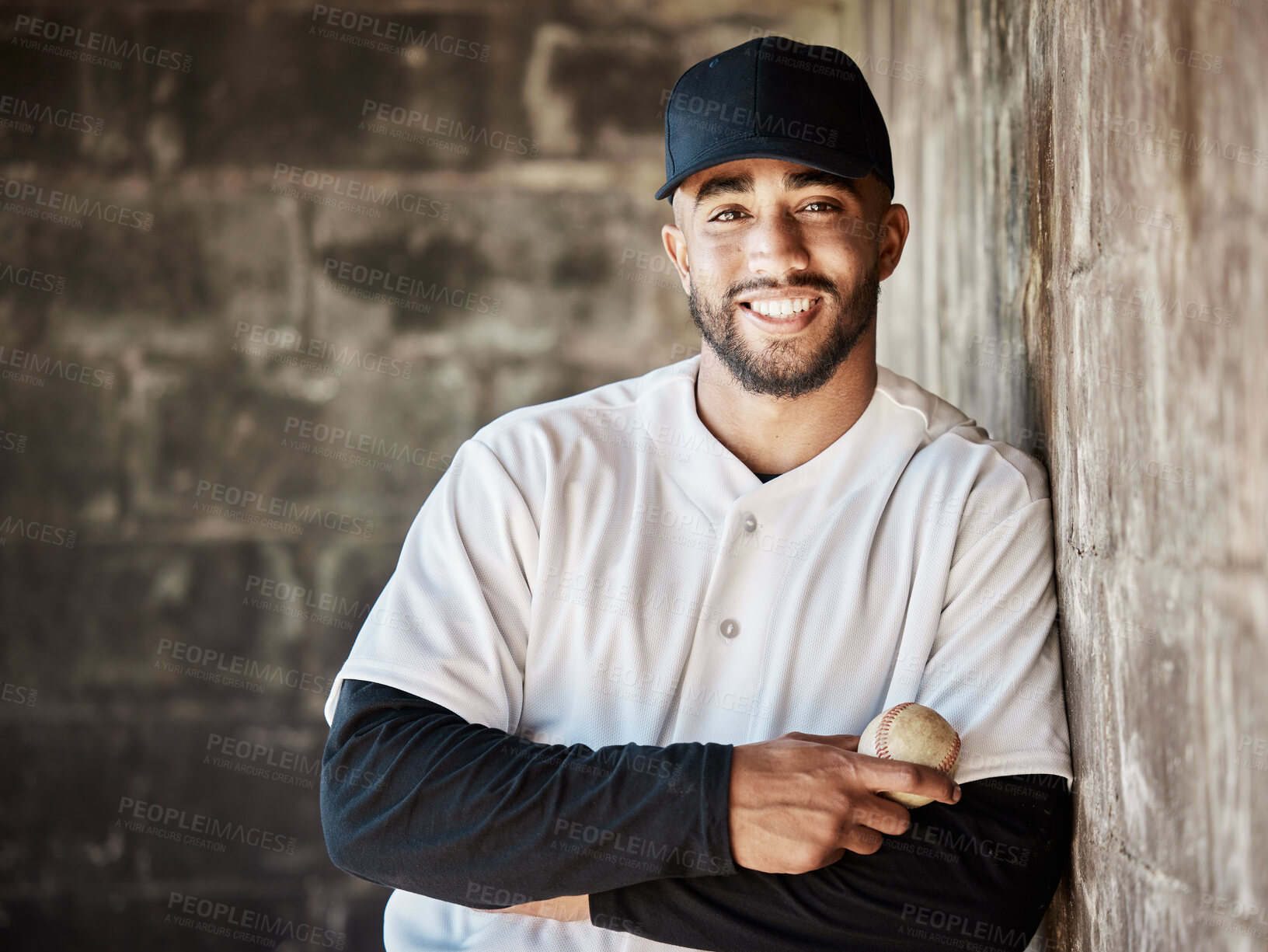 Buy stock photo Wall background, baseball and portrait of man with ball ready for game, match and practice in stadium. Softball mockup, sports and happy player smile in dugout for training, exercise and competition