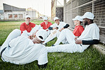 Baseball team, communication and stadium grass with sport group sitting on a fitness break. Training, exercise and workout of young people together laughing outdoor in a conversation in summer