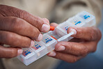 Medicine, container and hands of old person with pills for organize, healthcare and prescription. Medical, pharmacy and wellness with senior citizen and medication for vitamins, antibiotics and drugs