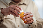 Medication, healthcare and male hands with pills for recovery, wellness and health in his home. Medicine, medical emergency and mature man taking tablets for a flu, cold or sickness in his house.