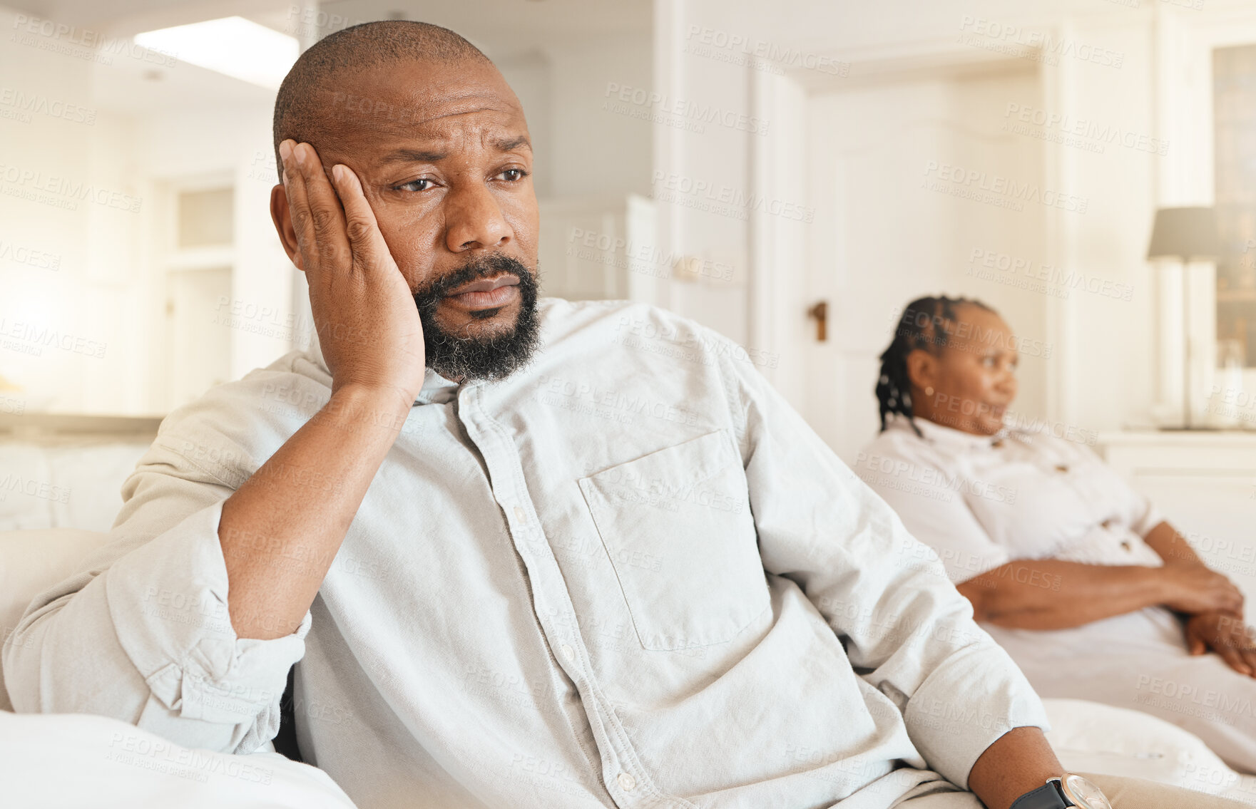 Buy stock photo Stress, depression and divorce of black man on sofa in home living room thinking after fight. Argument, sad and male with anxiety after marriage conflict, cheating or break up, disagreement or affair