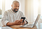 Phone, laptop and remote work with a black man manager checking his schedule from the home office. Mobile, contact and communication with a senior male ceo working in the living room of his house