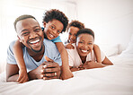 Happy, laughing and portrait of a black family on a bed for playing, quality time and comfort. Bonding, love and African children with parents in bedroom for happiness, relaxation and stress relief