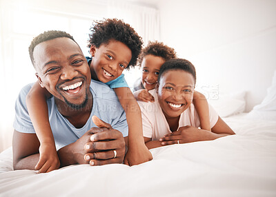 Buy stock photo Happy, laughing and portrait of a black family on a bed for playing, quality time and comfort. Bonding, love and African children with parents in bedroom for happiness and relaxation in the morning