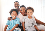 Happy, relax and portrait of black family in bedroom for morning routine, wake up and bonding. Affectionate, happiness and smile with parents and children at home for weekend, support and positive