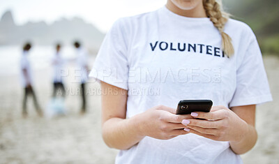 Hands, phone and volunteer woman at beach for cleaning, social media and web browsing. Earth day, environmental sustainability and female with 5g mobile smartphone at seashore for community service.