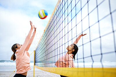 Buy stock photo Volleyball, beach and exercise with sports women playing a game outdoor for training or competition. Team, sport and female friends on the sand by the coast to spike a ball during a competitive match