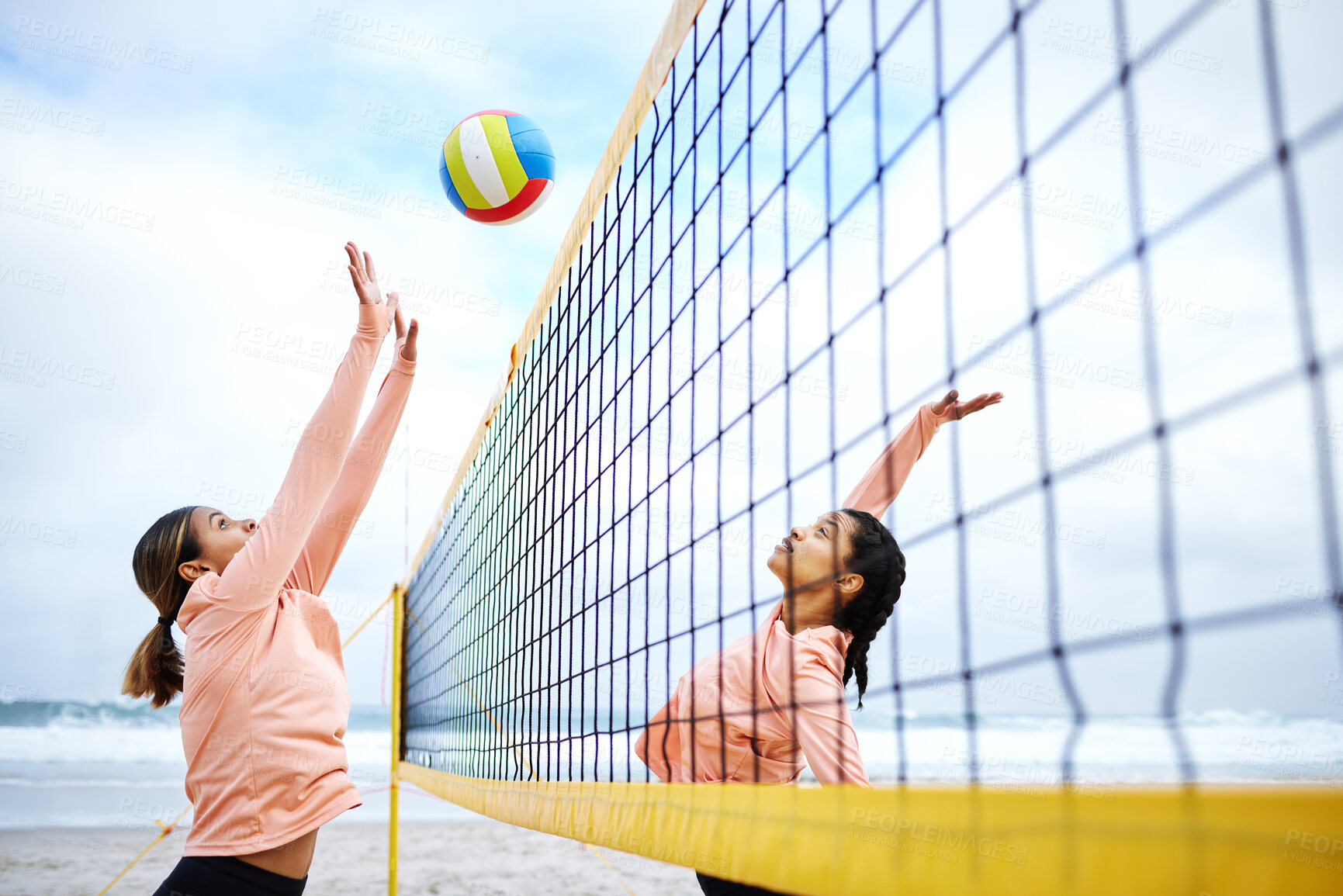 Buy stock photo Volleyball, beach and exercise with sports women playing a game outdoor for training or competition. Team, sport and female friends on the sand by the coast to spike a ball during a competitive match