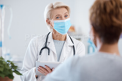 Buy stock photo Tablet, covid doctor and woman consulting in hospital for health and wellness. Healthcare, face mask and patient in consultation with senior medical professional with touchscreen technology in clinic
