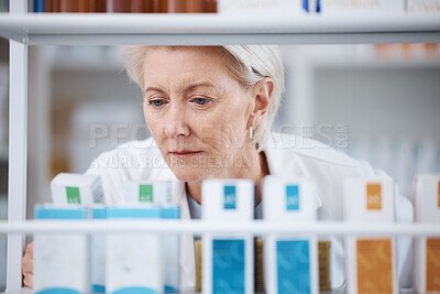 Buy stock photo Senior woman, shop stock and pharmacist check shelf in a pharmacy for drug information. Healthcare, wellness and working elderly person with pharmaceutical drugs reading box product ingredients