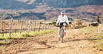 Man, mountain bike and cycling on path in nature, countryside and training for triathlon, sports and race. Cyclist, bicycle and off road trail for marathon fitness, exercise and freedom in sunshine