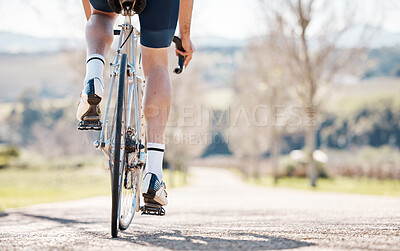 Buy stock photo Back of man, bike wheel and park path for fitness, training and triathlon sports in sunshine. Legs, cycling and bicycle on road for outdoor exercise, power and performance action with summer freedom