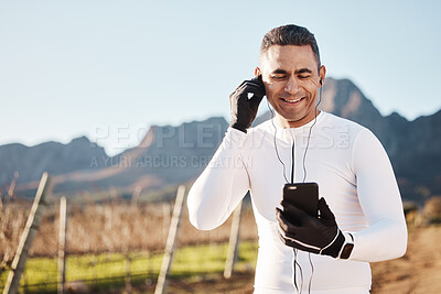 Buy stock photo 5g, earphones and nature, happy man and phone at rest stop in countryside looking at location online with music. Mobile streaming, fitness app and smartphone, cyclist on internet search with smile.