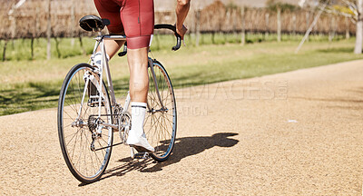 Buy stock photo Back of man, bicycle and path in park, exercise and training of triathlon sports in sunshine. Cyclist legs, bike and outdoor cycling trail for freedom, cardio fitness adventure and performance mockup