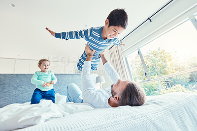 Buy stock photo Love, father and kid in air, bed and quality time on break, happiness or bonding together. Family, dad or lifting boy in bedroom, cheerful or playing with joy, game or freedom with affection or smile