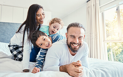 Buy stock photo Family, portrait and laughing on bed in home, having fun and bonding together. Comic, love and care of happy father, mother and kids or boys playing, smile and enjoying quality time in house bedroom.