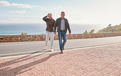 Buy stock photo Travel, road and senior couple walking enjoy holiday, adventure and vacation holding hands on mountain. Retirement, love and happy old man and woman for bonding, quality time and relax together