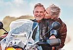 Travel, kiss and senior couple on motorcycle for adventure, freedom and road trip on weekend in retirement. Love, travelling and happy man and woman ride on motorbike for holiday, vacation or journey