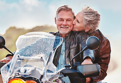 Buy stock photo Travel, kiss and senior couple on motorcycle for adventure, freedom and road trip on weekend in retirement. Love, travelling and happy man and woman ride on motorbike for holiday, vacation or journey