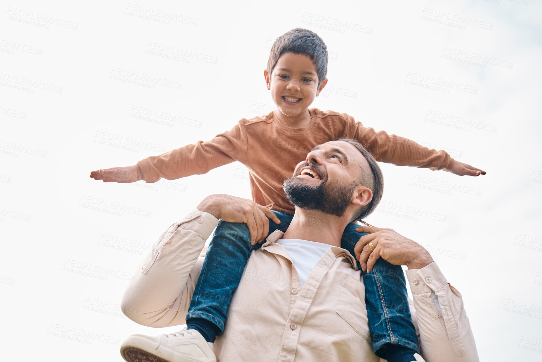 Buy stock photo Family, kids and boy sitting on the shoulders of his father outdoor while bonding from below. Fun, children and love with a man carrying his son outside while spending time together being playful