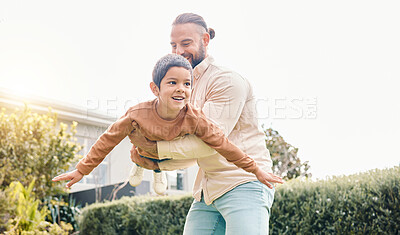 Buy stock photo Carefree, flying and playing father with a child in a garden for freedom, play and bonding. Happy, laughing and dad holding a boy kid to fly while enjoying time in the backyard of a house together