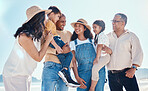 Kids, beach and summer with a black family together outdoor on the sand by the ocean or sea for holiday. Children, love or nature with siblings, parents and grandparents bonding outside on the coast