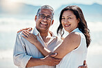 Love, beach and portrait old couple in embrace, smile on face and romance in happy relationship. Romantic retirement vacation, senior woman and mature man hugging on tropical ocean holiday travel.
