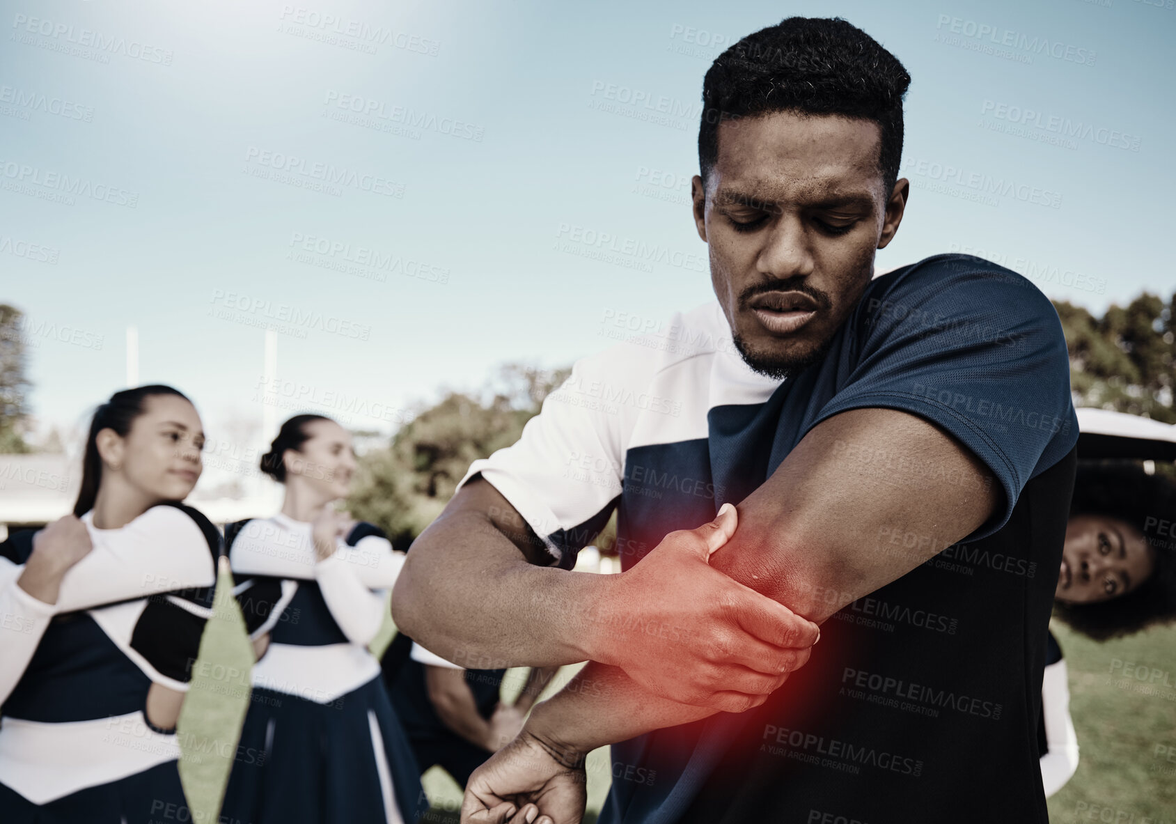 Buy stock photo Cheerleader, sports or man with elbow pain, injury or accident on field in game or training match. Red glow, fitness or cheerleading male athlete with a medical emergency, joint or muscle sprain 