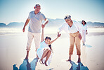 Beach, family holding hands and grandparents with kid playing and walking on ocean sand together. Fun, vacation and happy senior man and woman with children bonding, quality time and summer in nature