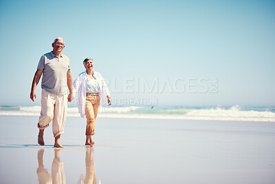 Buy stock photo Holding hands, summer and an old couple walking on the beach with a blue sky mockup background. Love, romance or mock up with a senior man and woman taking a walk on the sand by the ocean or sea